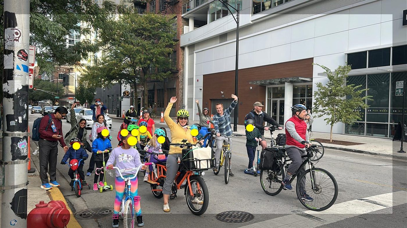 The bike bus gathered at an intersection, waving